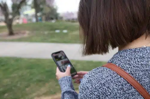 Pregnant woman at a park, looking for the best pregnancy tracking app