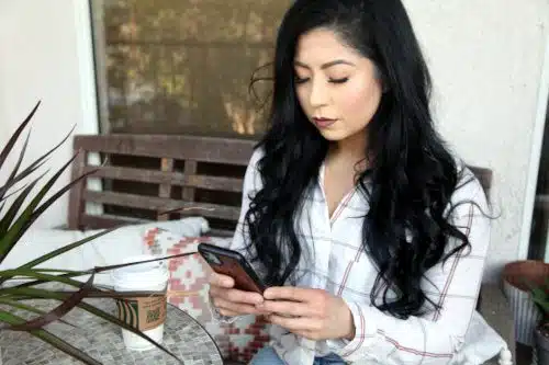Woman sitting her patio, drinking Starbucks and learning about adoption