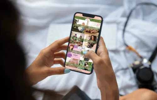 Woman's hands holding a phone with the Open Adoption app showing
