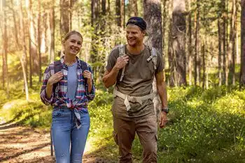 couple walking in woods