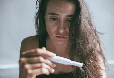 woman looking at pregnancy test
