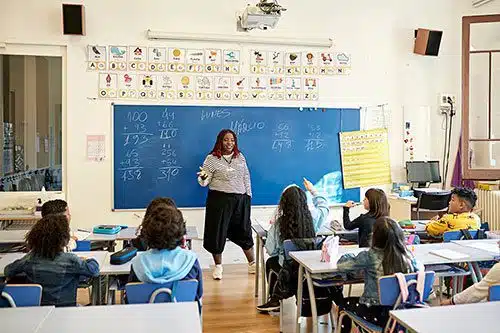 Teacher lecturing to students about a math lesson