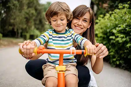 adoptive mom with son on bike