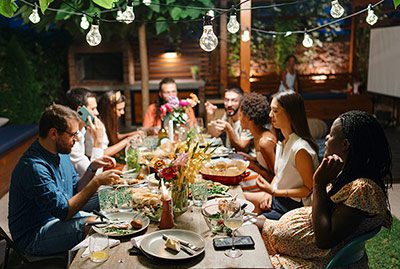 Pregnant woman enjoying Thanksgiving dinner outside with friends