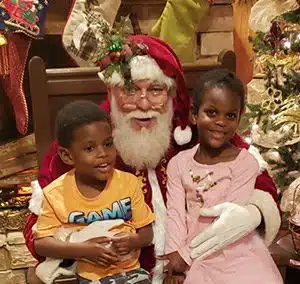 Chris and Amanda's children pose with Santa