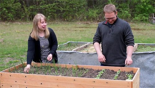 Hopeful adoptive parents Harlie and Cody tending to their garden