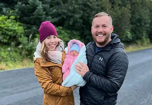 Excited adoptive parents Liesa and Brant holding their daughter