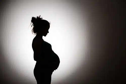 shadow of pregnant woman wanting to remain in a closed adoption