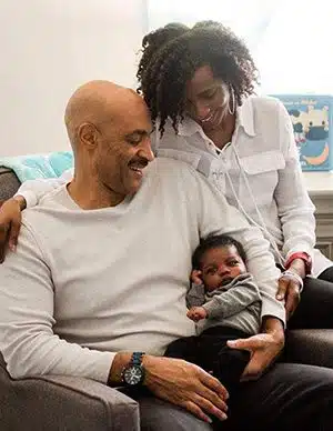 Adoptive mom story showing parents Aaron and Kimberly gaze lovingly at their son