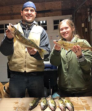 Ryan and Jess show of their catches from a recent fishing trip