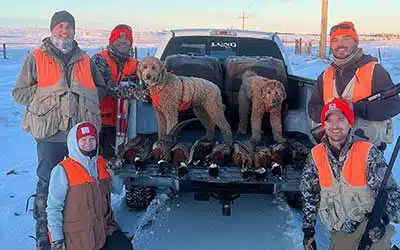 Ryan and Jess pose with friends after pheasant hunting
