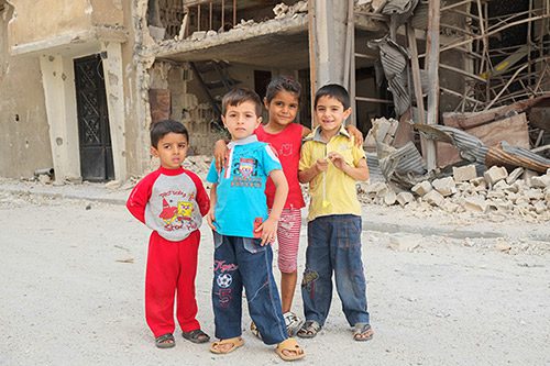 Children in Syria pose for a photo in the aftermath of an earthquake