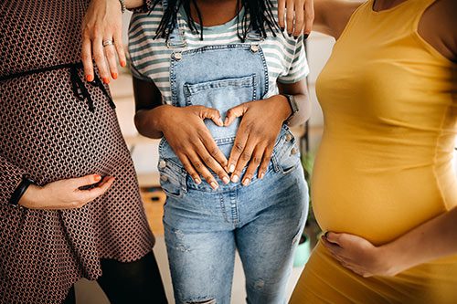 Portrait of three young pregnant women about what is a birth mother like