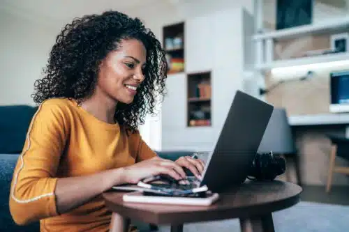 Woman typing up a letter of recommendation for adoption in her living room