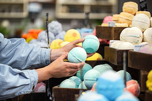 Woman selecting the bath bombs she'd like to buy at an adoption fundraising craft booth