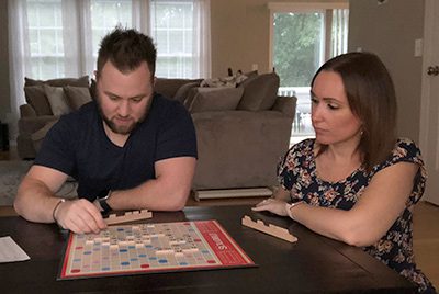 Chris and Jill concentrating on a game of Scrabble in their living room