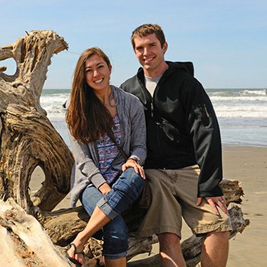 couple hoping to adopt posing on Oregon beach