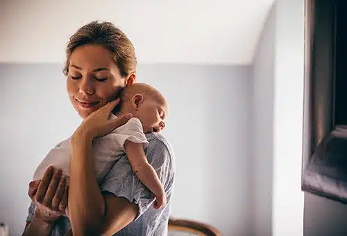 Adoptive mother savors the moment after following newborn care tips for sleeping