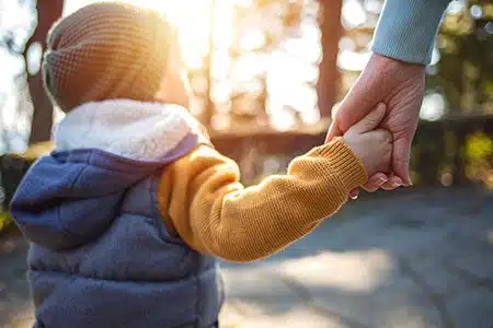 toddler holding adult hand