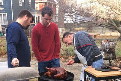 David helping his family members grill the Thanksgiving turkey