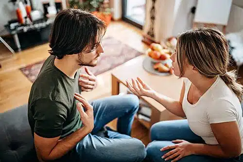 A young couple arguing in their living room