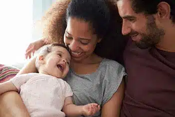 Adoptive parents holding baby after completing Lifetime's adoption application form and process