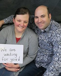 Hopeful adoptive parents Jeremy and Angela with an adoption wait sign