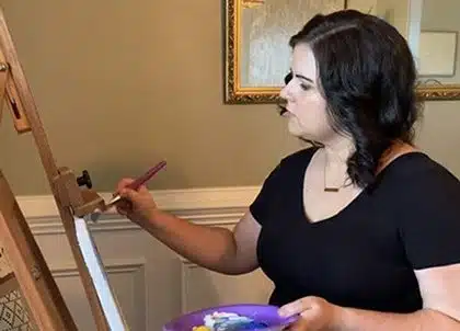 Rachel works on a painting