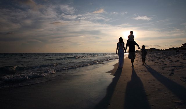 adoptive family walking on beach in Florida