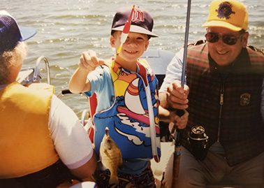 Scott shows off his catch after fishing with family as a kid