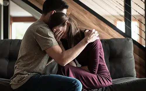Husband comforts his crying wife as she faces Mother's Day grief