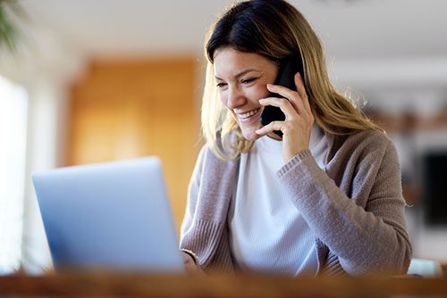 woman on phone looking for adoption agencies