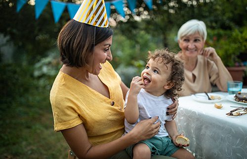 Adoptive mom smiling at her child after searching for adoption party ideas