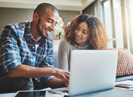 couple figuring out how to afford adoption with calculator