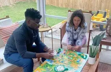 James and Lauren playing a game in their three seasons room 
