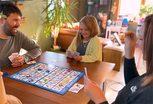 Jared and Andrea playing a children's version of Sequence with their daughter