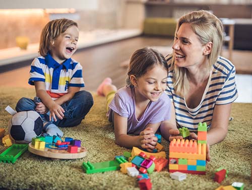 mom playing with two adopted kids