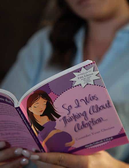 woman reading pregnancy options book