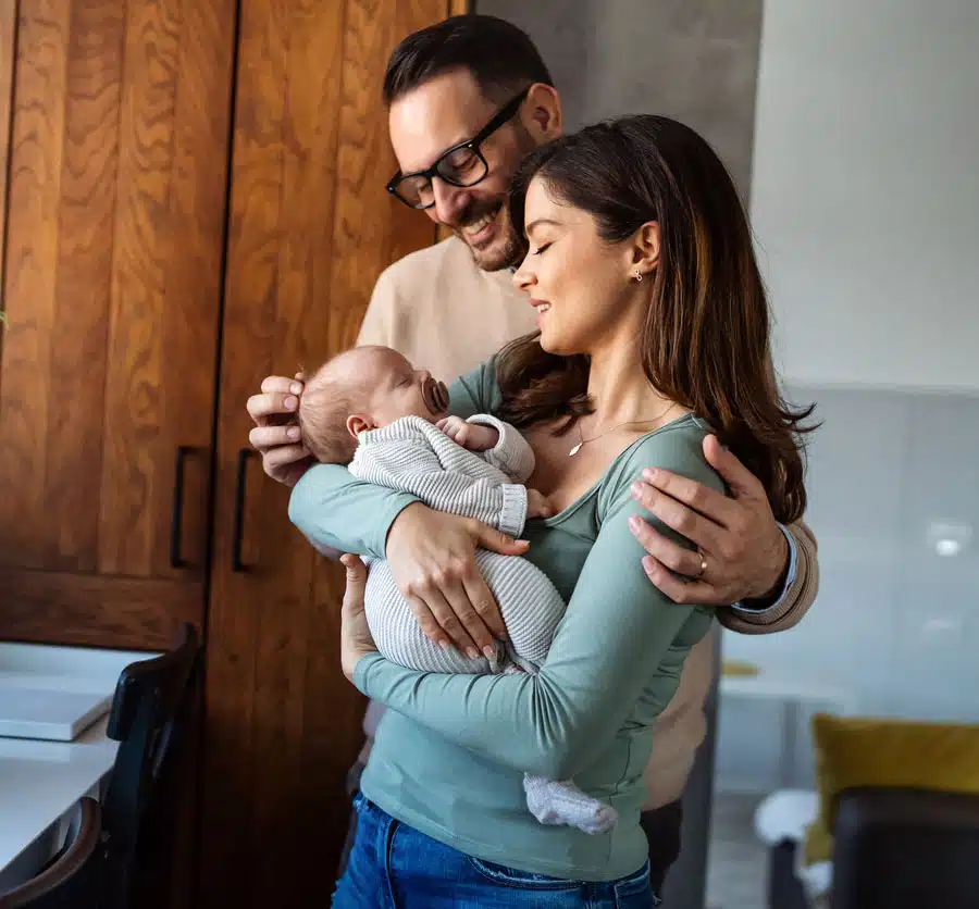 AF_FamilyBaby adoptive family admiring their baby