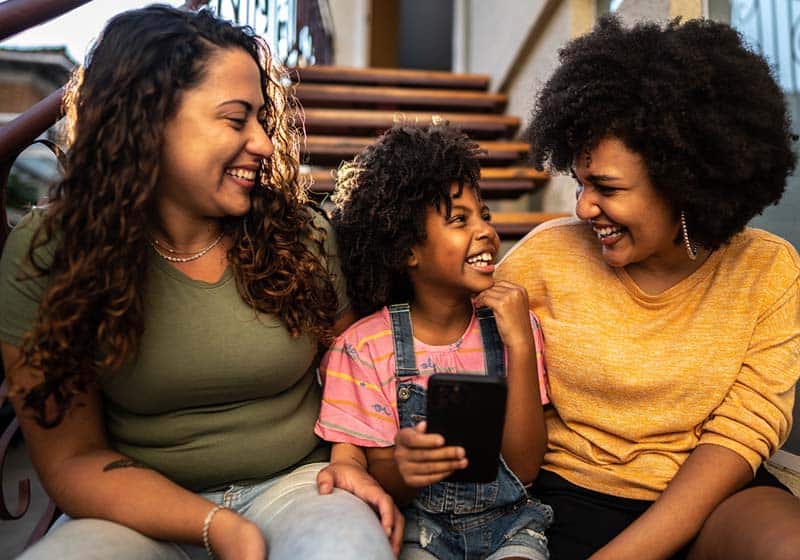 birth mom adoptive mom and child in an open adoption