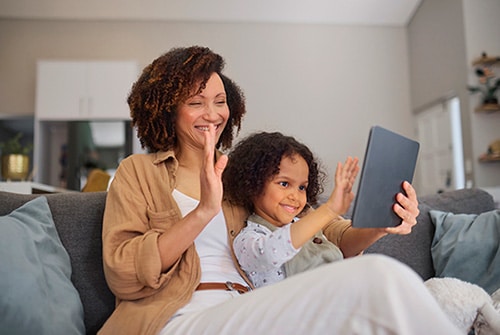 Adoptive mother and her daughter on a video call with the girl's birth mother