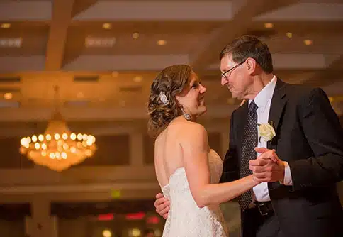 Emily dancing with her father at her wedding