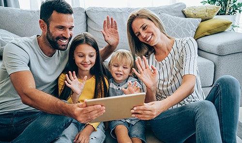 Adoptive parents and children on a video call with birth parents