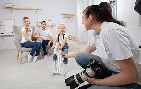 A photographer photographs a new adoptive family in her studio