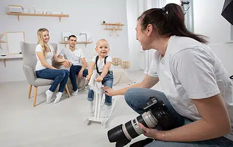 A photographer photographs a new adoptive family in her studio