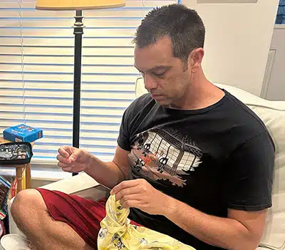 Travis mending in the living room