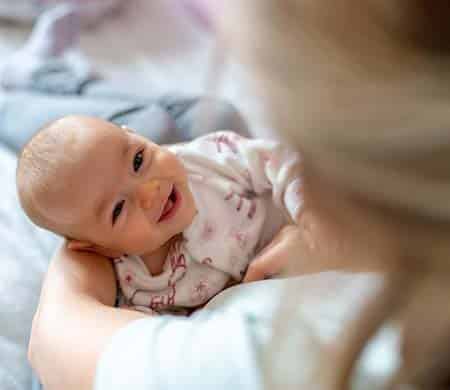 adopted baby smiling at her adoptive mom