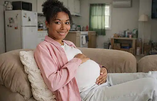 Pregnant woman relaxing on her sofa at home