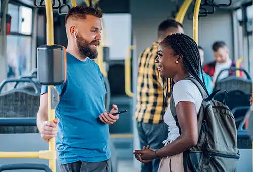 Strangers making small talk while riding a bus in the city