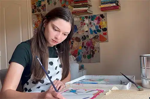 Hopeful adoptive mom Beverly painting in her studio